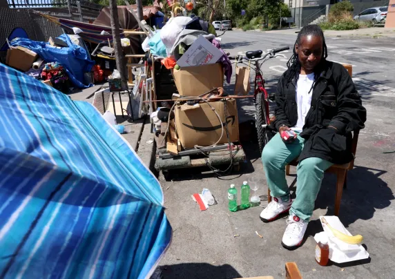 Person sitting next to a tent