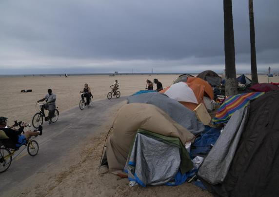 Tents line a path near a beach