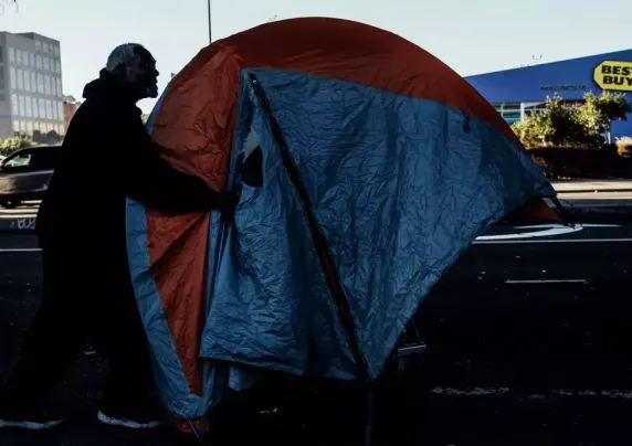 A man next to a tent