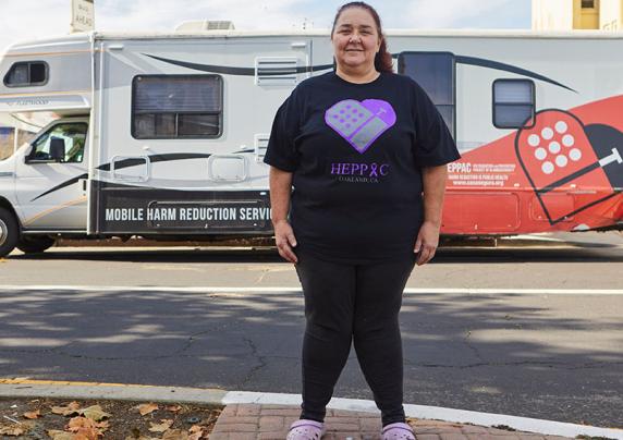Woman standing outside a mobile medical unit