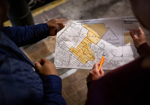 Photo of two people holding a map