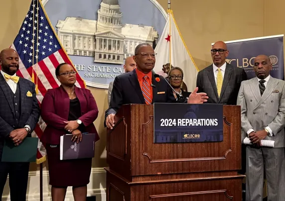 People standing around a podium