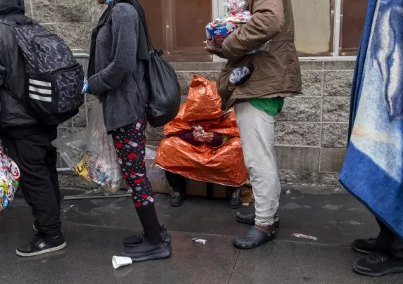 Queue of women on a sidewalk