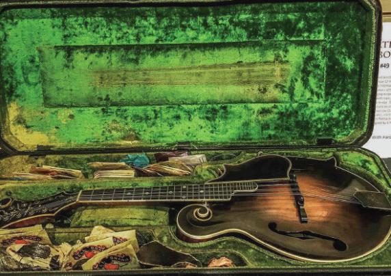A rare mandolin in a green case.