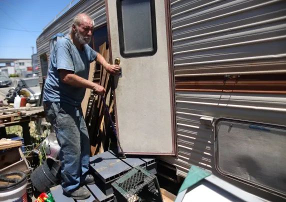 A man opens a trailer door