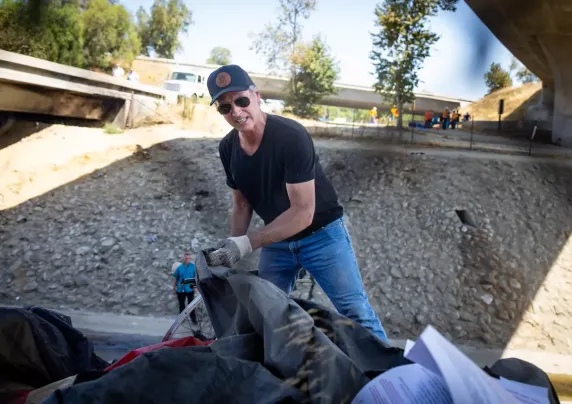 Gov. Gavin Newsom cleaning up an encampment site