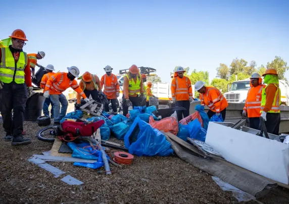 Workers cleaning up an encampment site