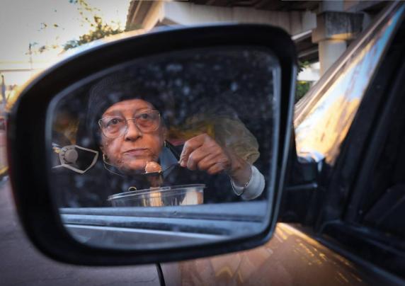 Woman eats a meal in her car