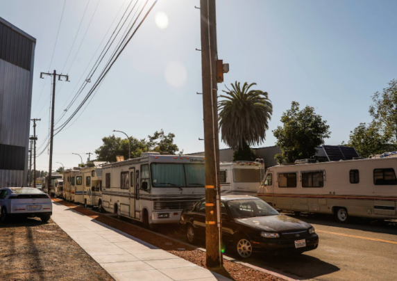 RVs lined up on both sides of a street.