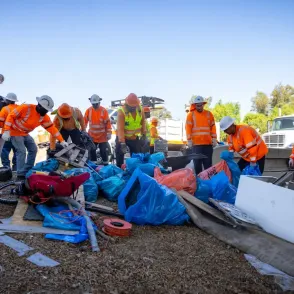 Workers cleaning up an encampment site